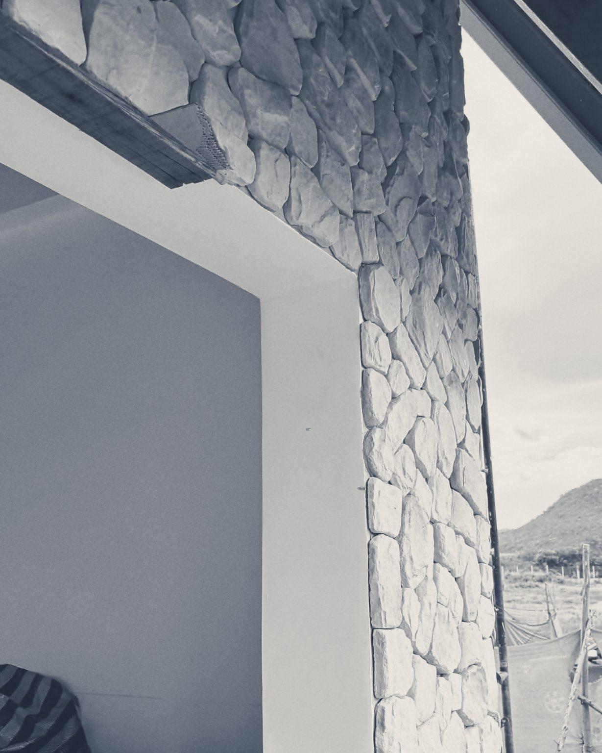 A stone-clad column framing the mountain