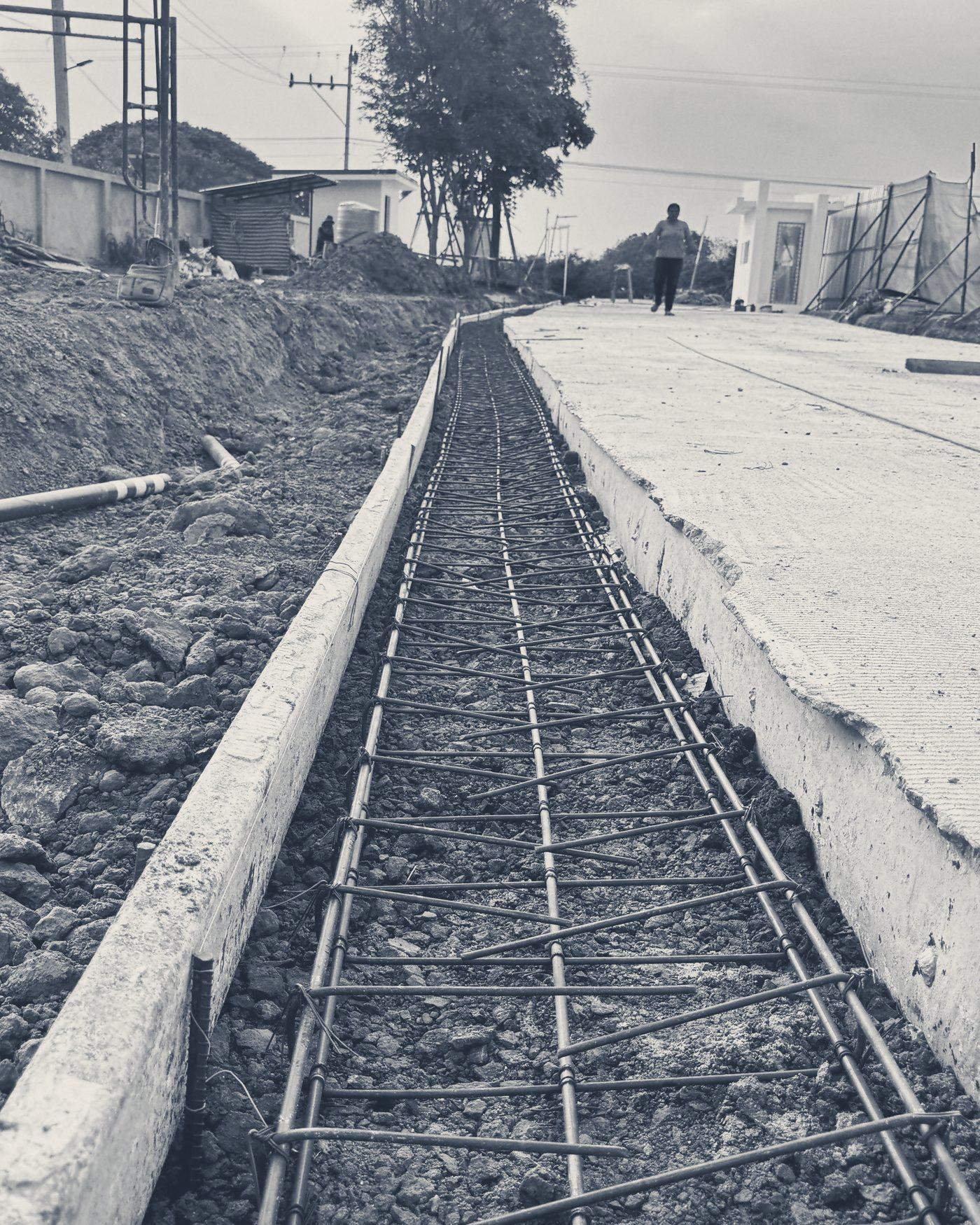 Rebar laid in the wall footing, running along the road