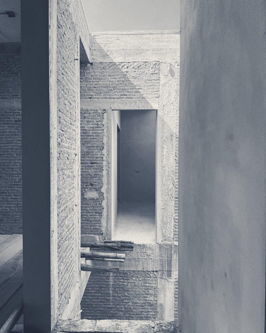 An upstairs opening framed in brick and fair-faced concrete
