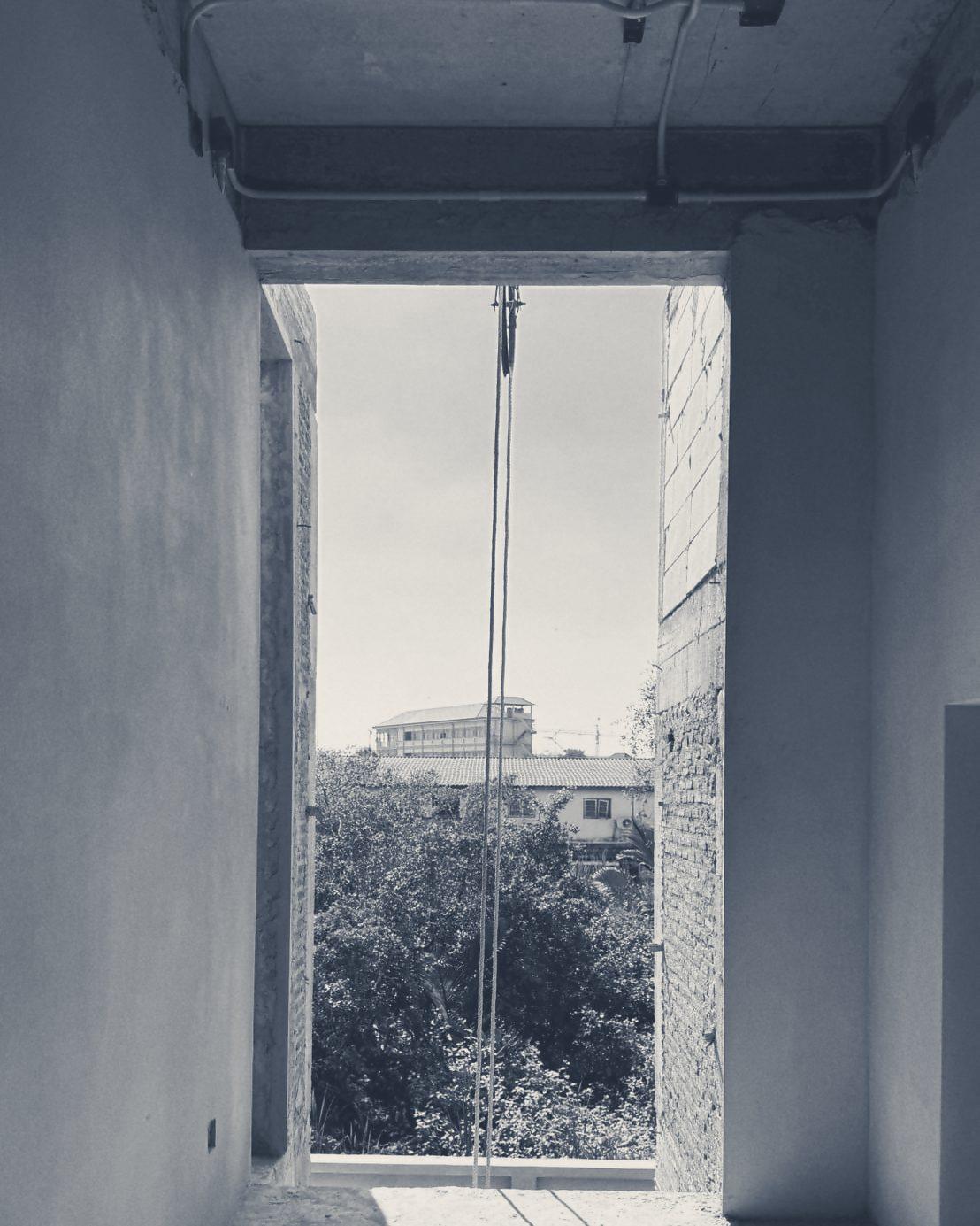 A tall upstairs opening looking out over the trees