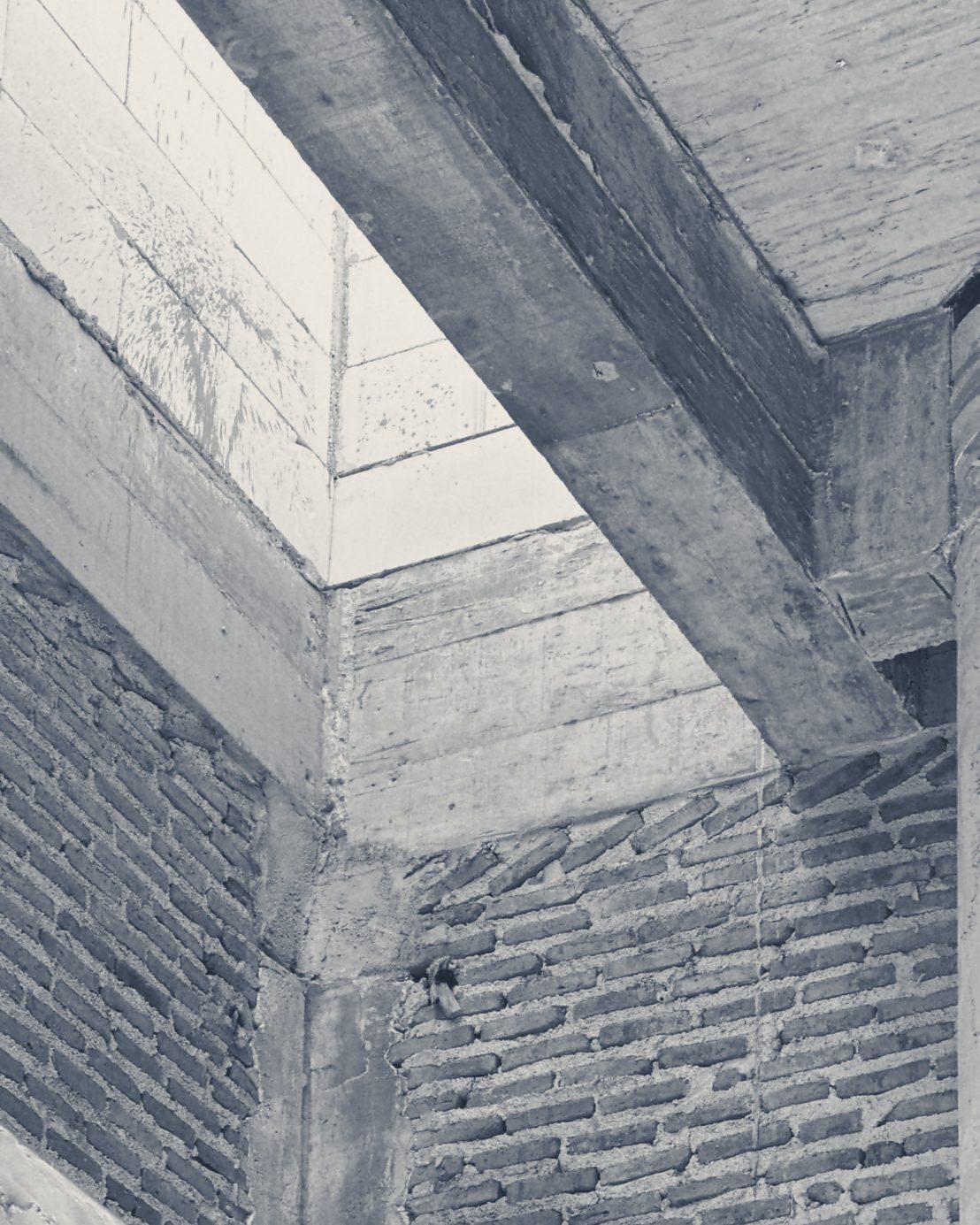 Brick infill meeting a concrete beam at a corner