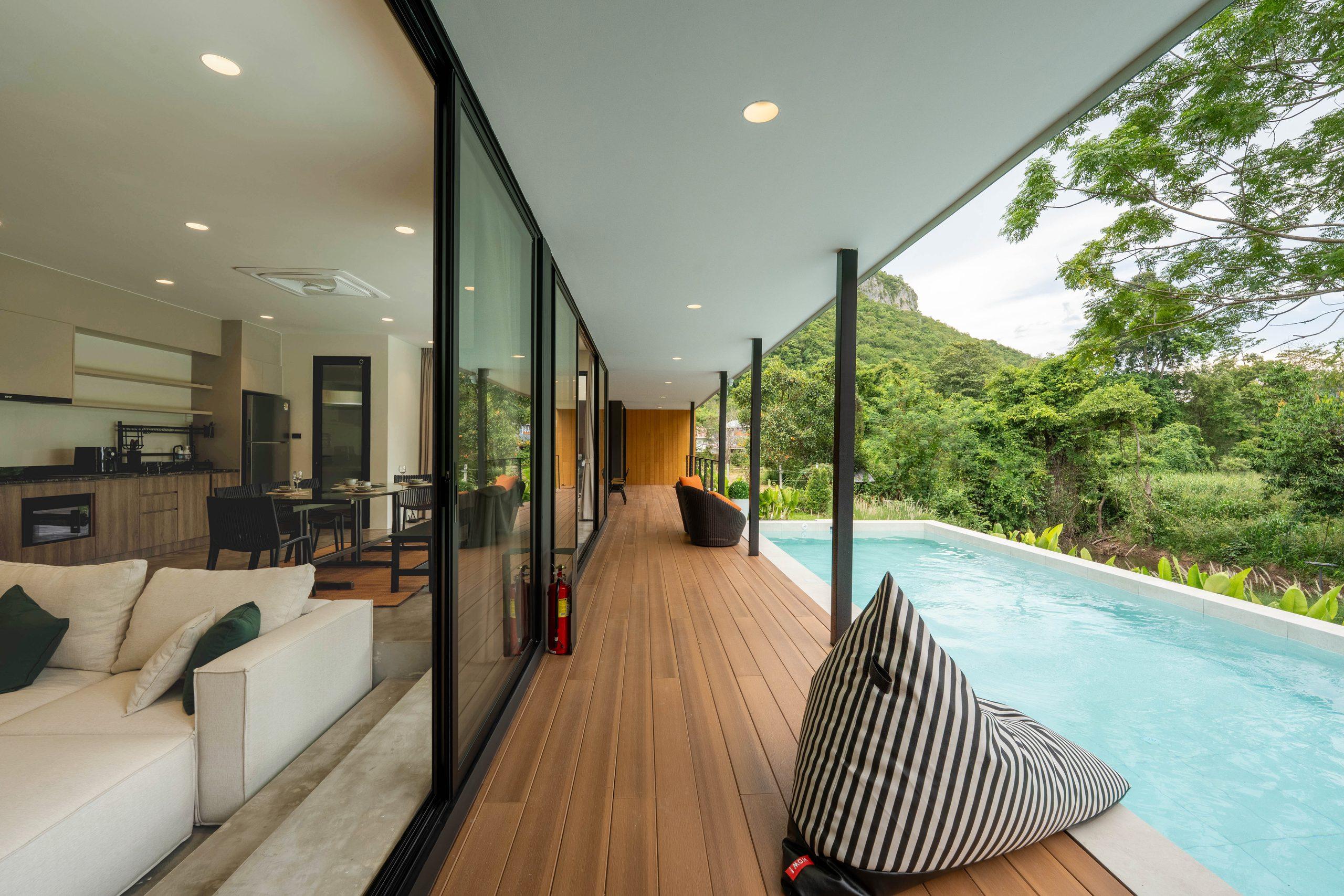 The living room opening onto the timber deck and the pool