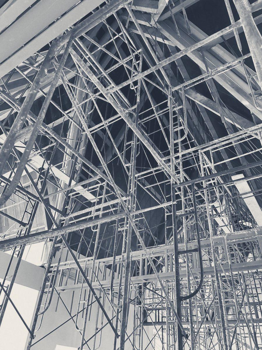 Looking up through scaffold into the roof steel of a gable