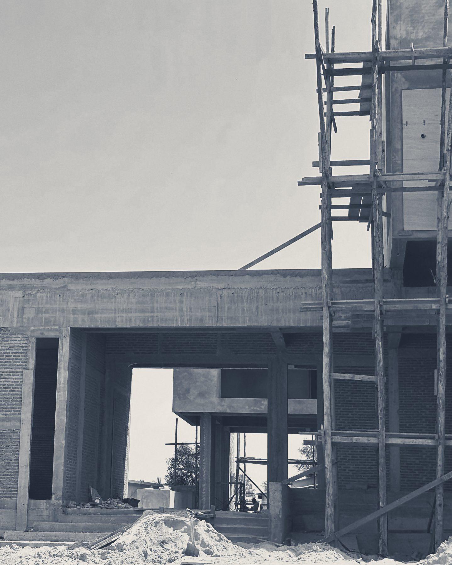 The concrete frame going up, with bamboo scaffold at the corner