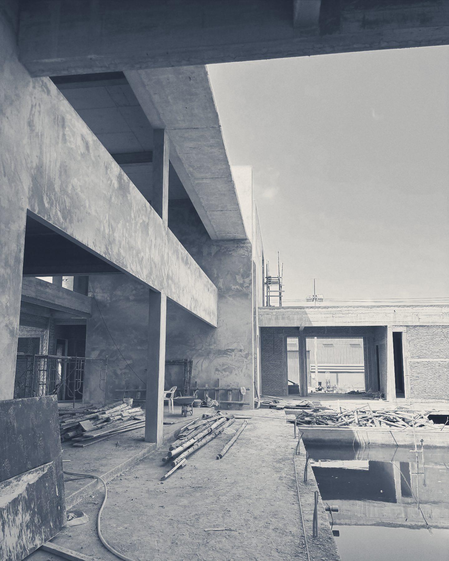 The concrete frame and the newly dug pool, with timber stacked on the slab