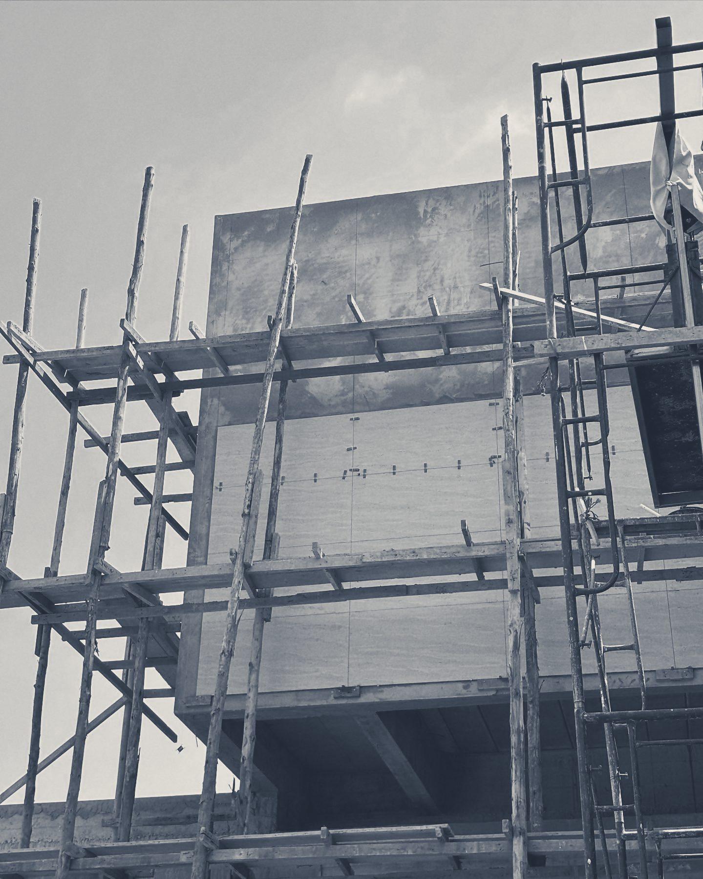 Cladding panels set out on the upper box, with scaffold still up